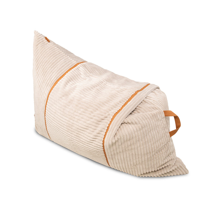 A triangular wedge-shaped lumbar pillow in beige corduroy fabric with contrasting orange-brown piping and a matching fabric handle, shown on a solid white background. 