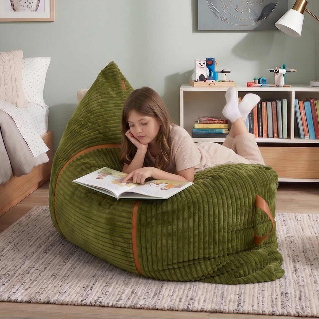 A young girl lies on a large olive green corduroy bean bag chair in a child&