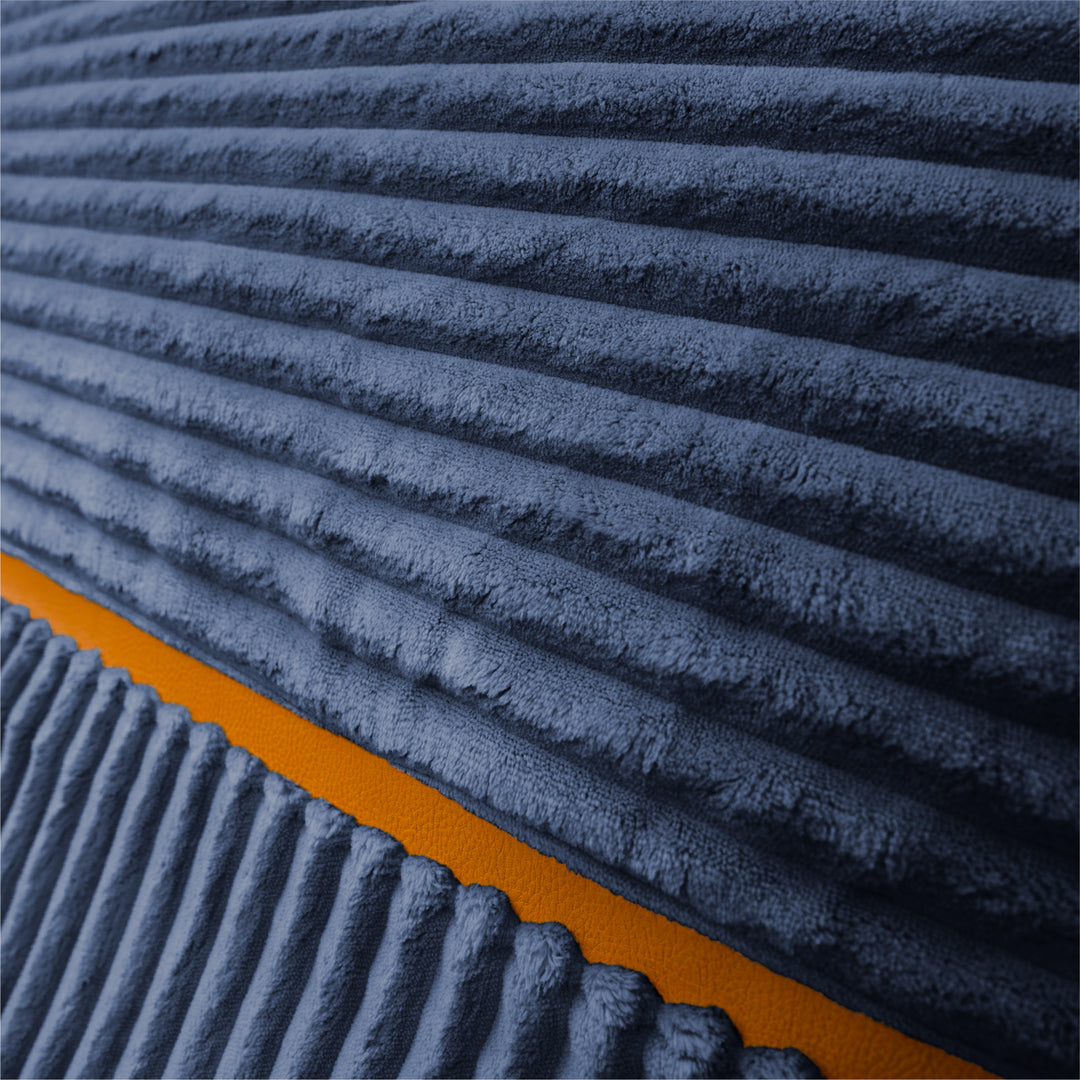Close-up of a ribbed corduroy fabric in dark blue-gray with a contrasting orange border. 