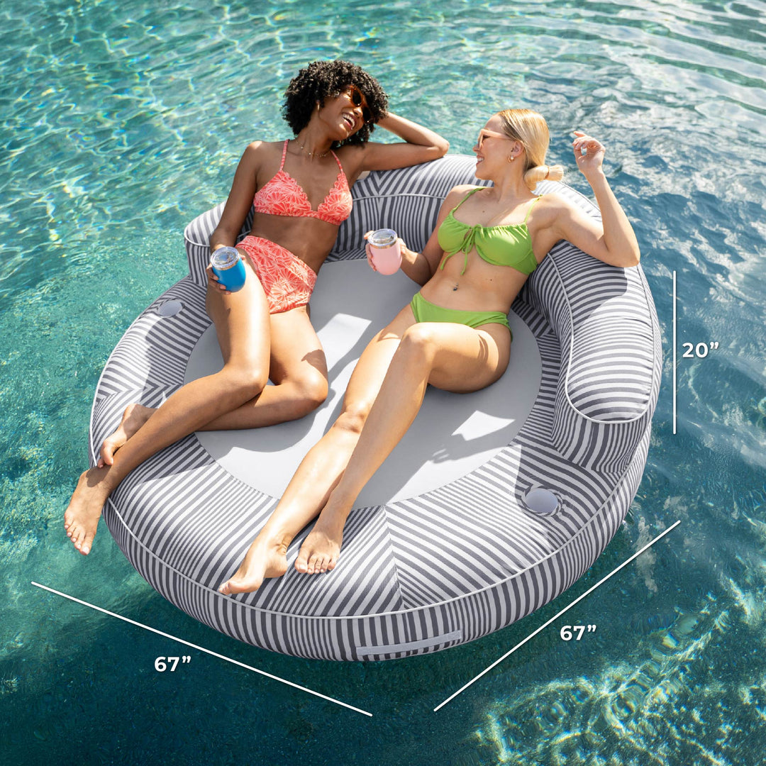 Two women relaxing on a circular pool float with measurements displayed. #color_shoreline-gray-stripe-olefin