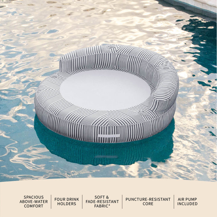 Inflatable pool float with striped design in a pool #color_shoreline-gray-stripe-olefin