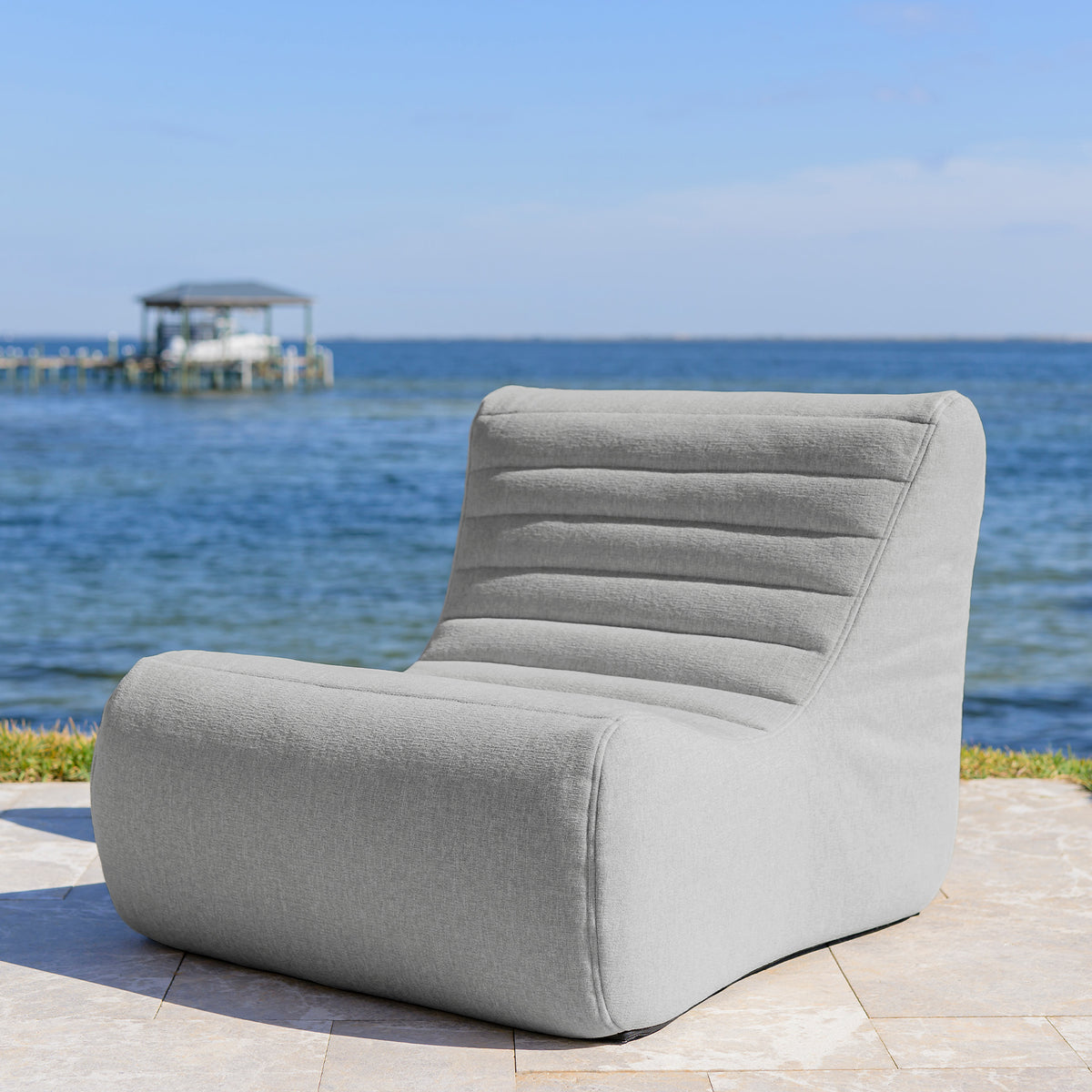 Gray patio chair on a patio with a scenic ocean view 