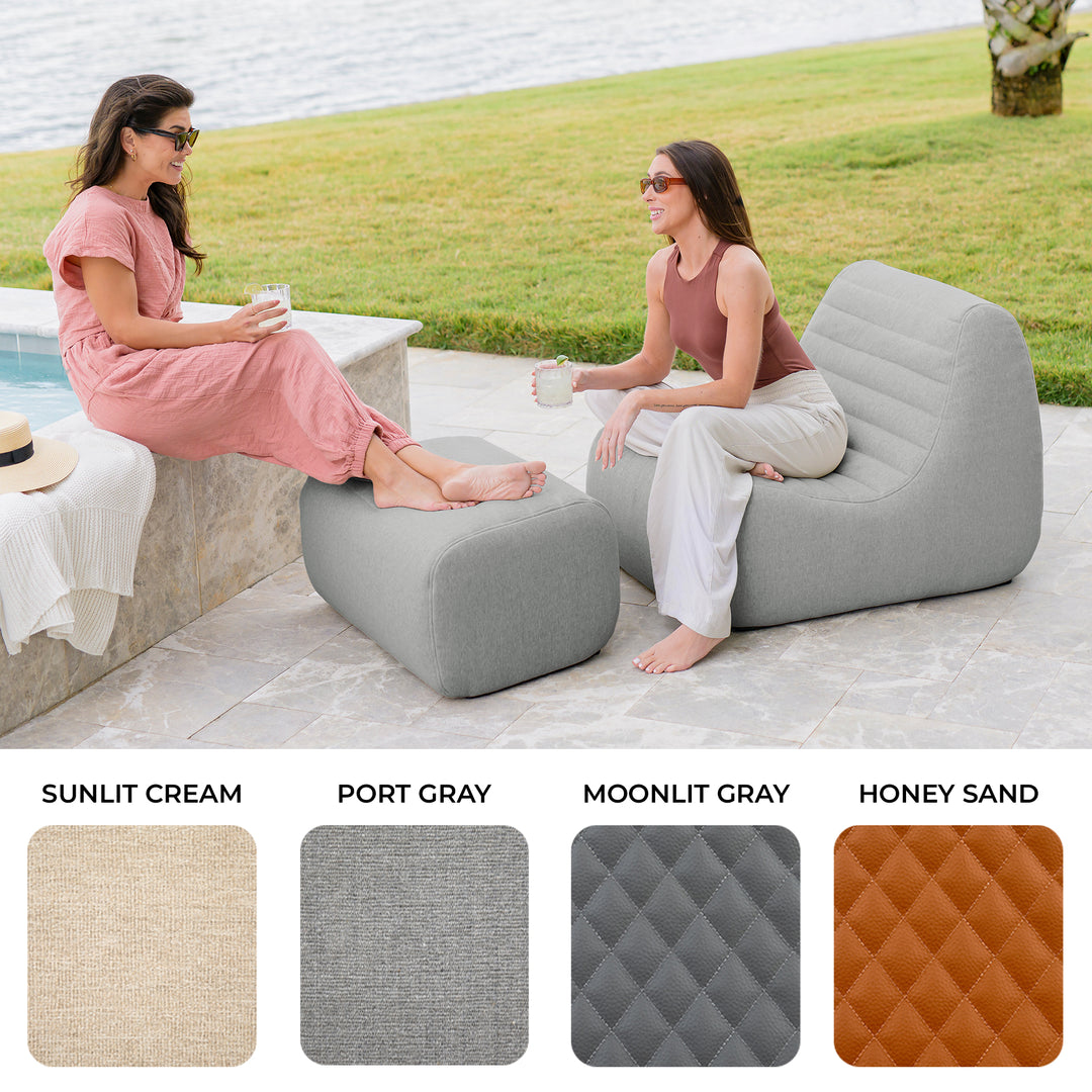 Two women sitting on lounge chairs by a poolside with color swatches below. #color_port-gray-outdoor-performance-linen