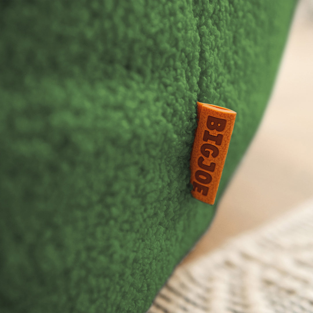 Green cushion with a brown &
