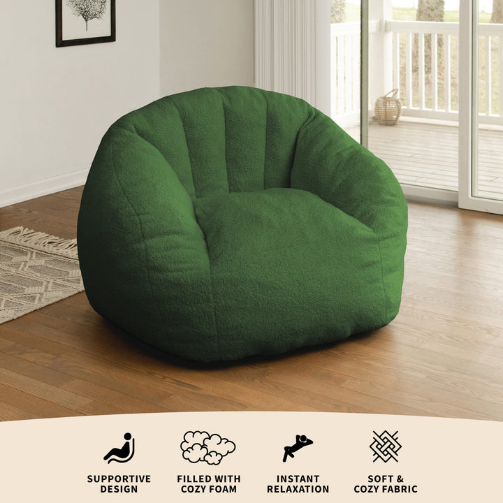 Green bean bag chair in a room with wooden floor and sliding glass door. 