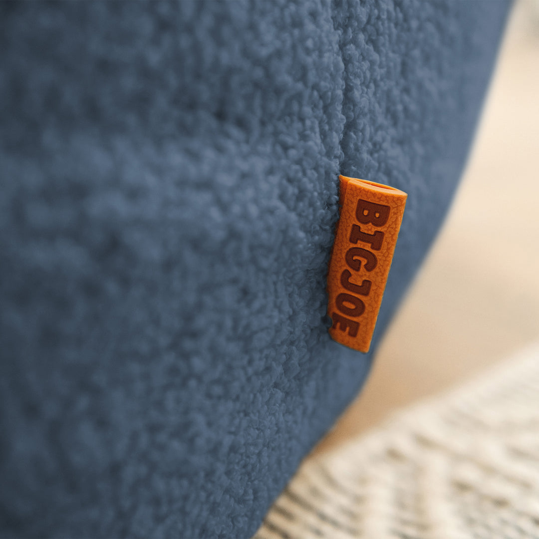 Close-up of a blue textured surface with a brown &