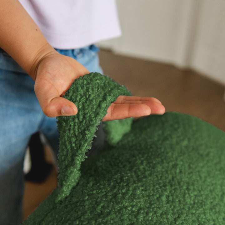Person holding a green textured fabric close-up 