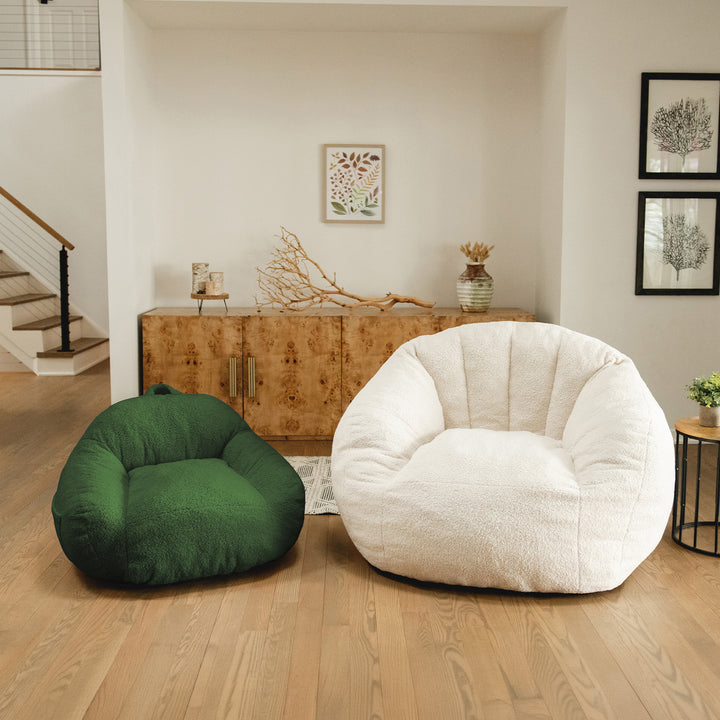 Two bean bags, one green and one white, in a living room setting. 