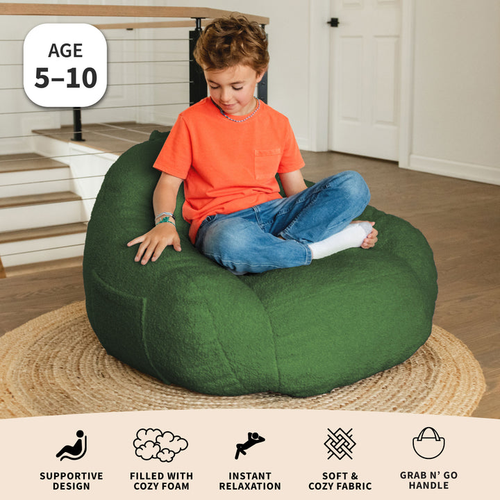 Child sitting on a green bean bag chair in a home setting with product features displayed. 