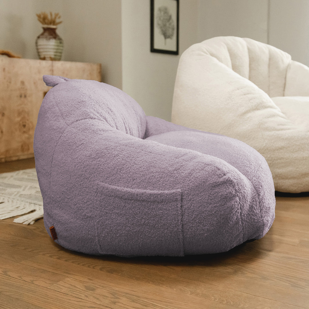 Purple bean bag chair in a room with a neutral color scheme 