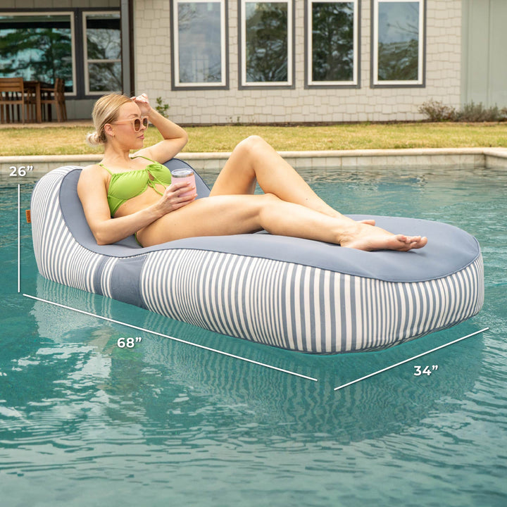 Woman lounging on a striped pool float in a pool with measurements displayed #color_weekend-navy-stripe-olefin