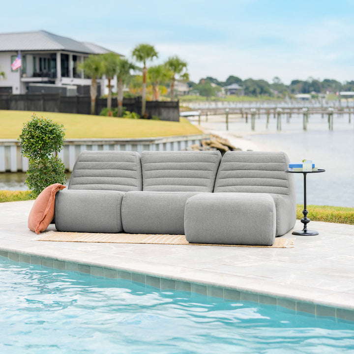 Gray outdoor sofa by a pool with a waterfront view #color_port-gray-outdoor-performance-linen