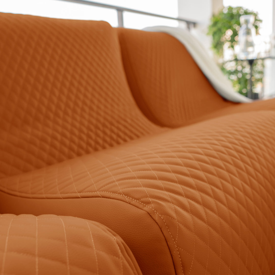 Close-up of an orange quilted sofa with a blurred background #color_honey-sand-outdoor-vegan-leather