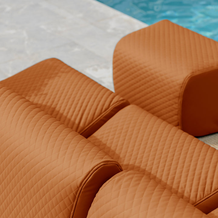 Brown quilted lounge chairs by a poolside #color_honey-sand-outdoor-vegan-leather