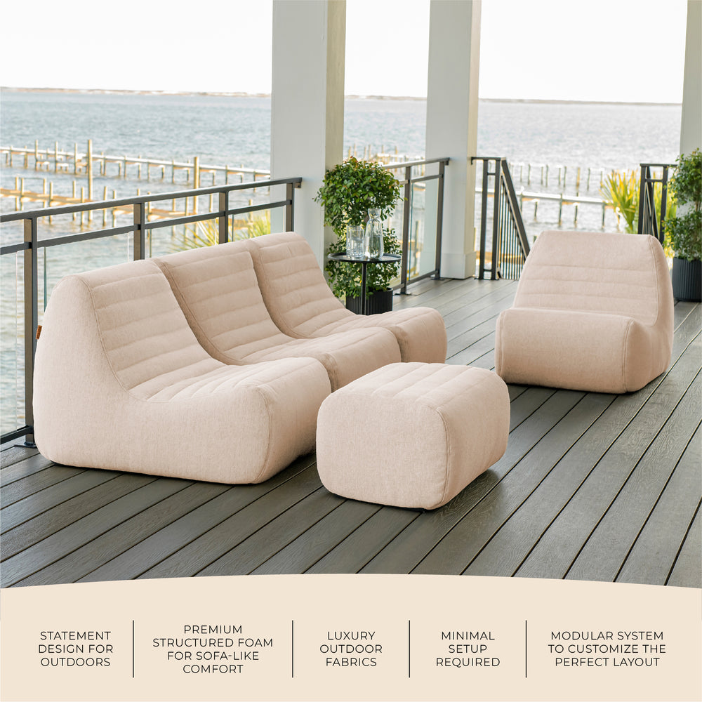 Beige outdoor sofa set on a deck with ocean view #color_sunlit-cream-outdoor-performance-linen