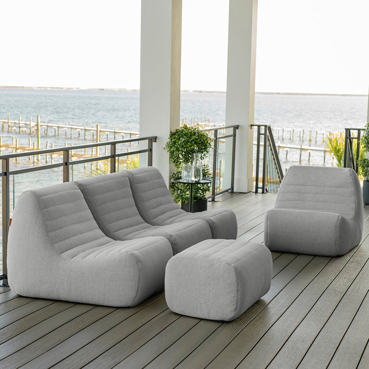 Gray outdoor furniture set on a wooden deck with a waterfront view. #color_port-gray-outdoor-performance-linen
