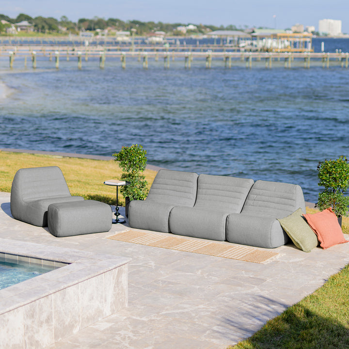 Gray outdoor sofa with colorful cushions by a waterfront #color_port-gray-outdoor-performance-linen