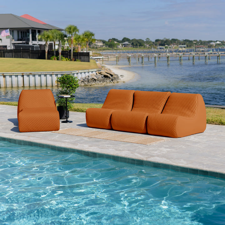 Orange outdoor sofa set by a pool with a waterfront view #color_honey-sand-outdoor-vegan-leather