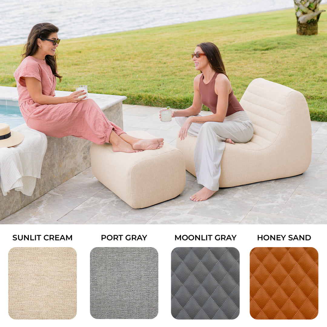Two women sitting on inflatable lounge chairs by a body of water, with color swatches below. #color_sunlit-cream-outdoor-performance-linen