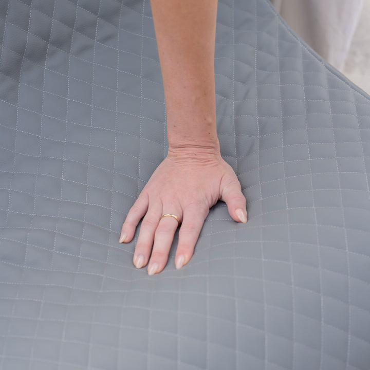 Hand on a textured gray surface #color_moonlit-gray-outdoor-vegan-leather