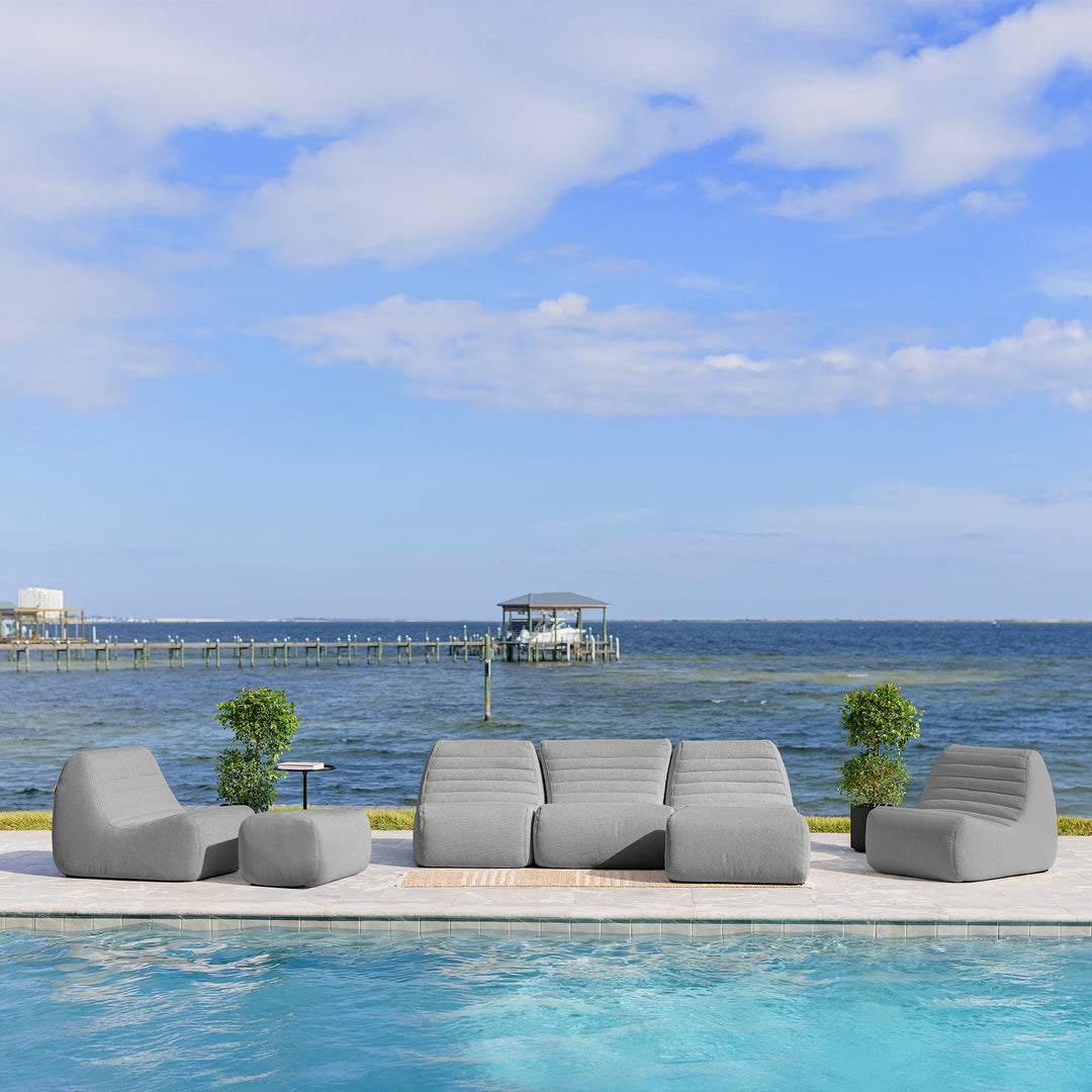 Gray outdoor sofa set by a pool with a scenic ocean view #color_port-gray-outdoor-performance-linen