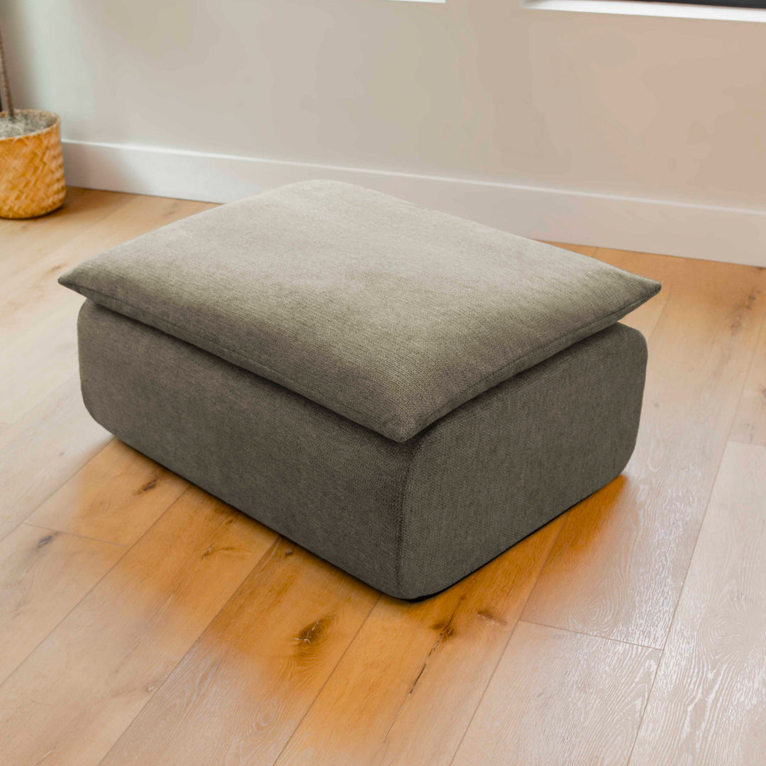Gray ottoman on a wooden floor 