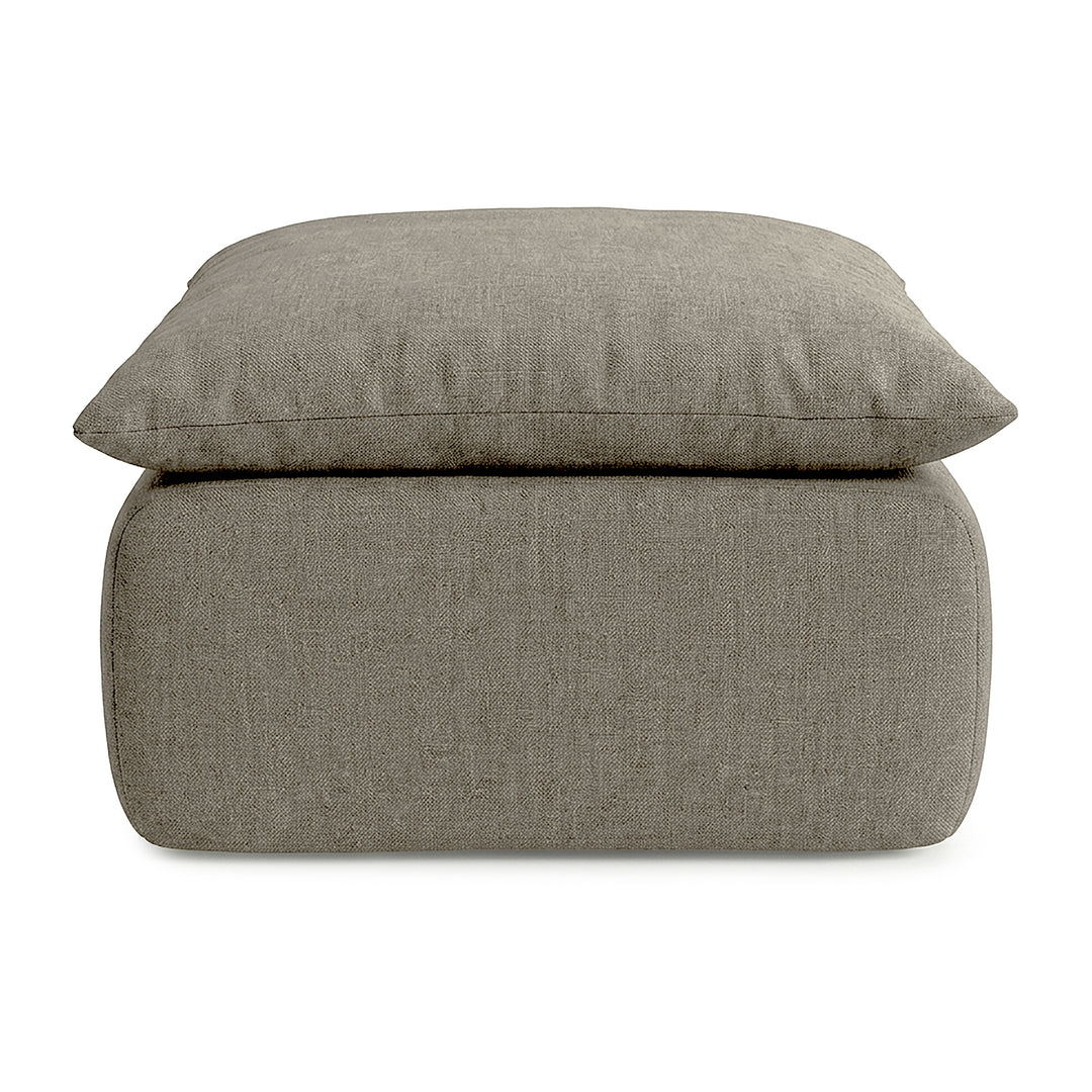 Gray fabric ottoman with cushion on a white background 