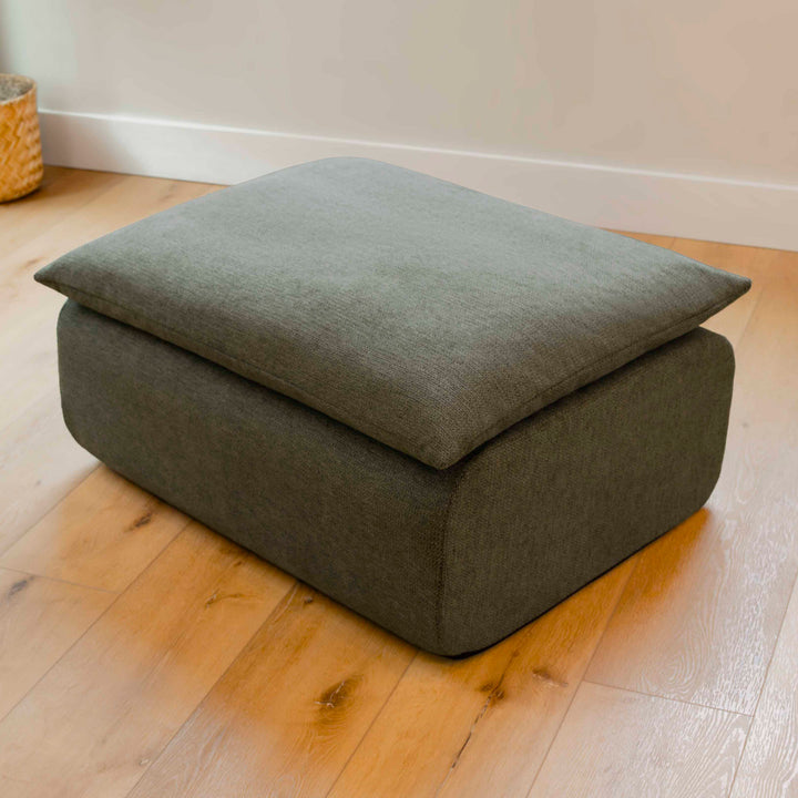 Gray ottoman on a wooden floor 