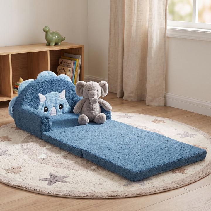 A blue plush toddler bed with a matching floor mat and cloud-shaped backrest, styled in a child&