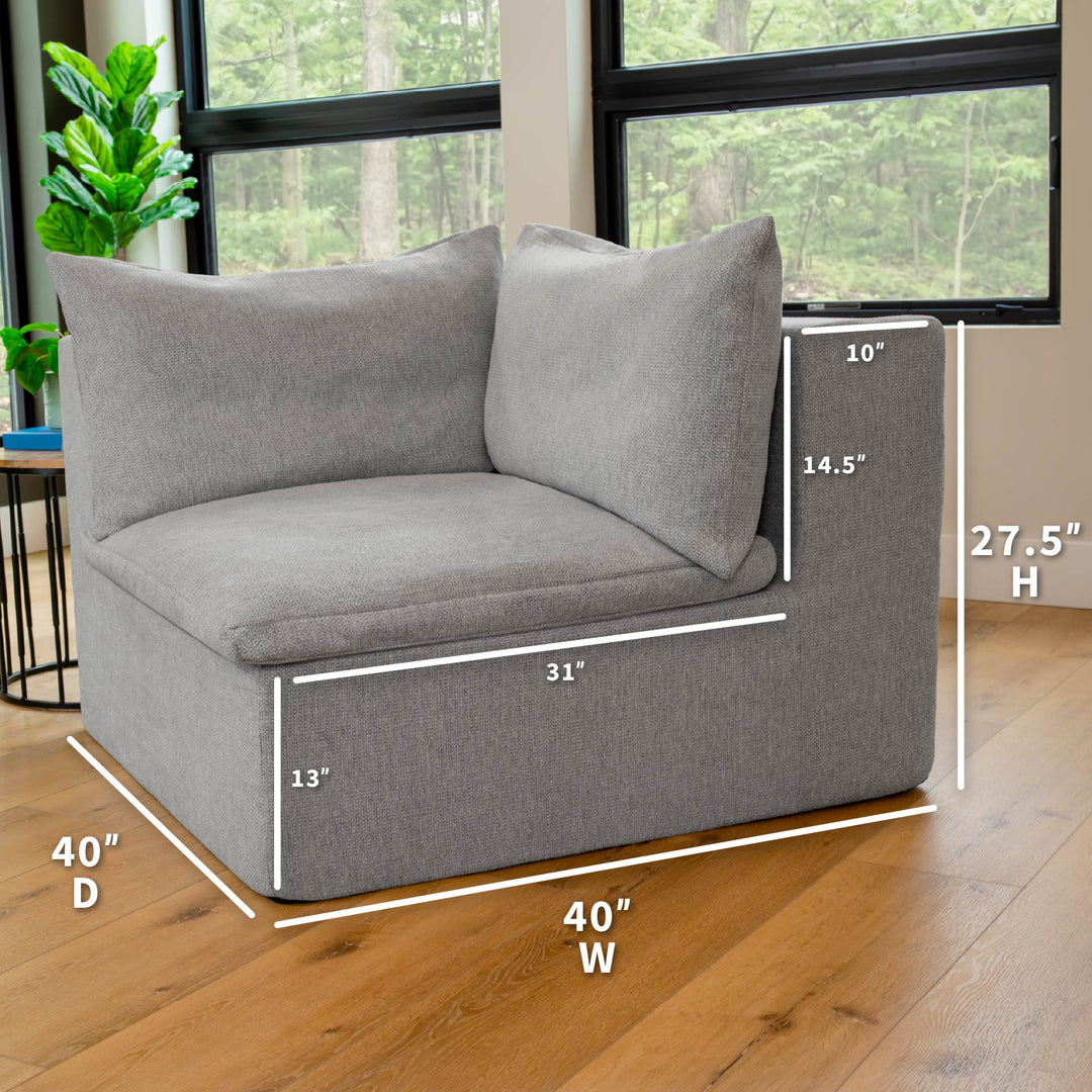Gray corner sofa with dimensions marked in a room with large windows and plants. 