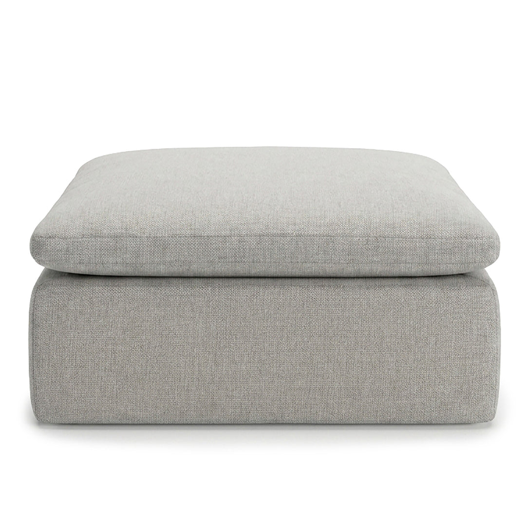 Gray upholstered ottoman on a white background 