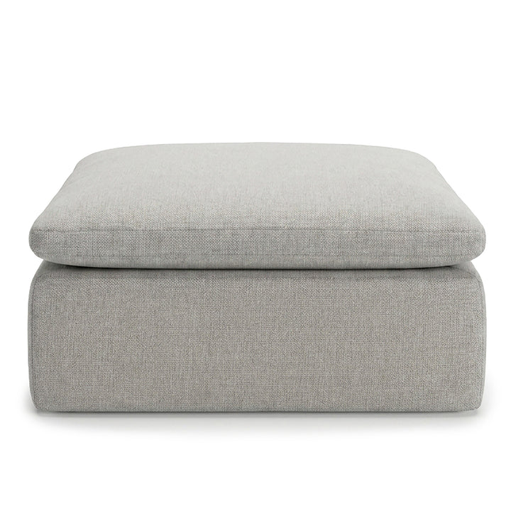 Gray upholstered ottoman on a white background 