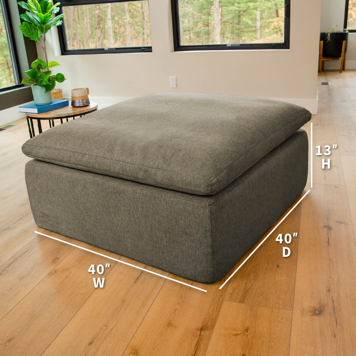 Averra Ottoman with product dimensions in a living room. 