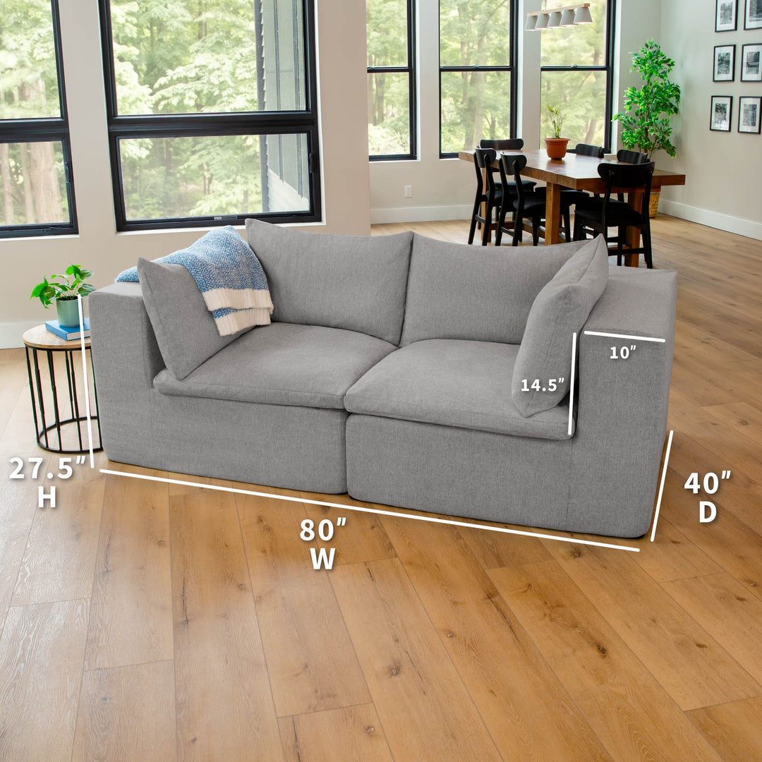 Gray sectional sofa with dimensions labeled in a living room setting 