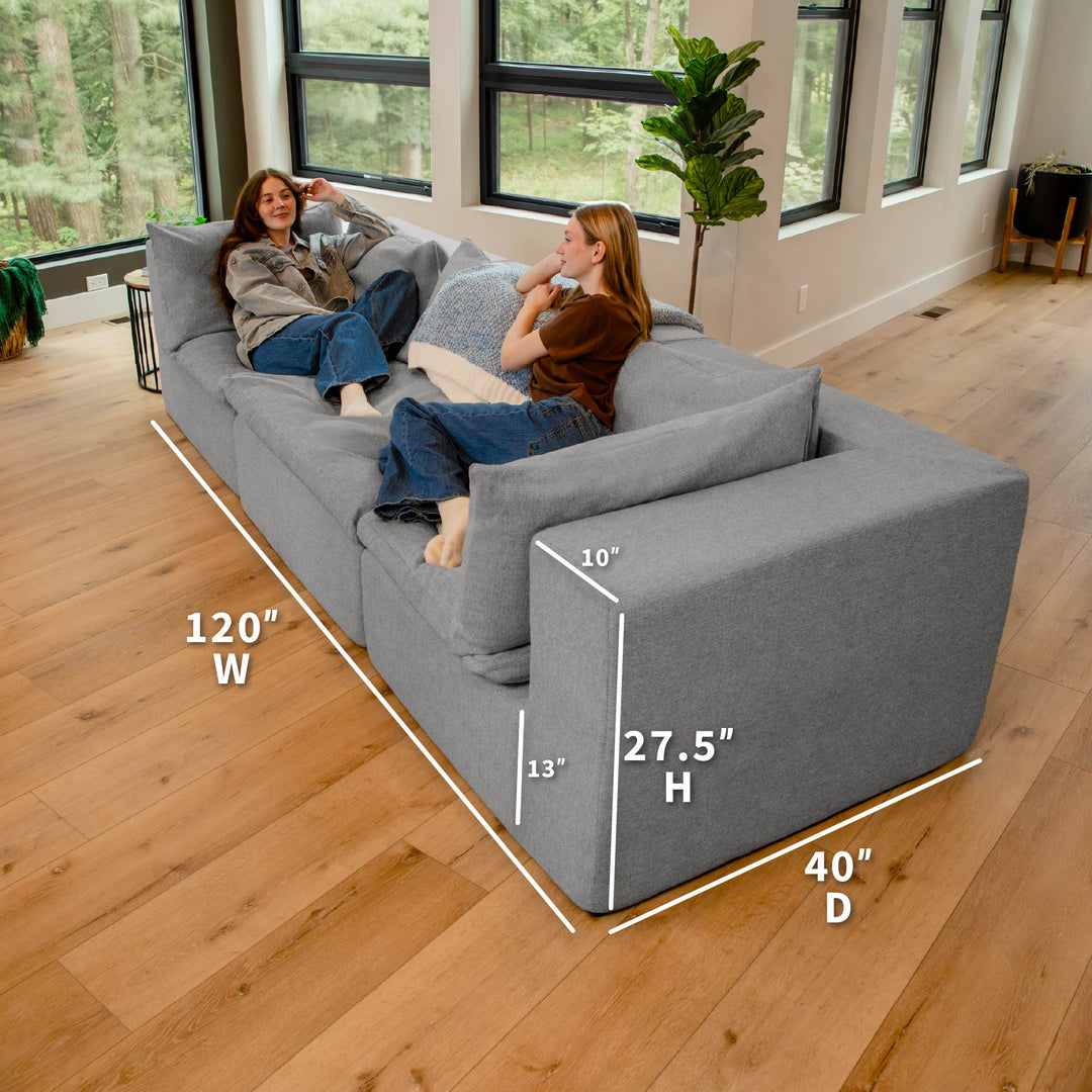 Gray sectional sofa with dimensions labeled in a living room setting 