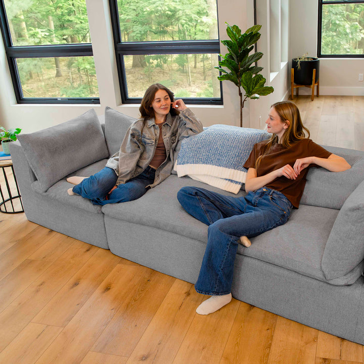 Women talking and sitting on a couch in the living room 