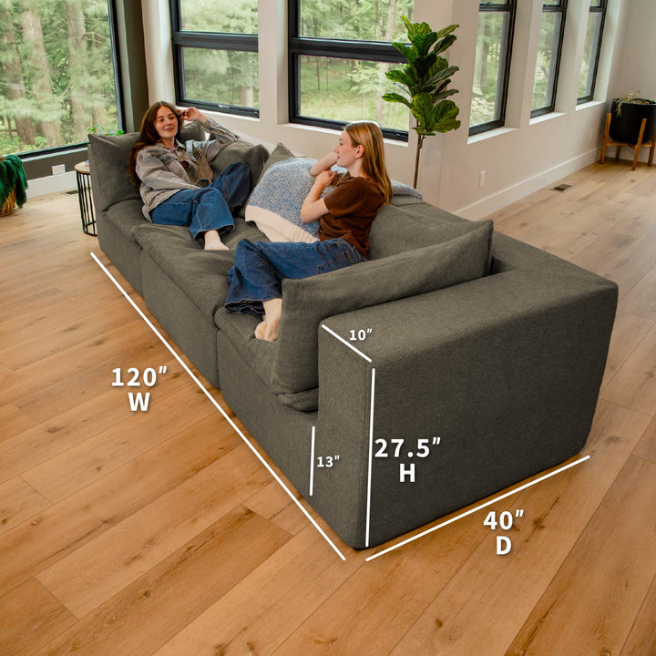 Gray sectional sofa with dimensions labeled in a living room setting 