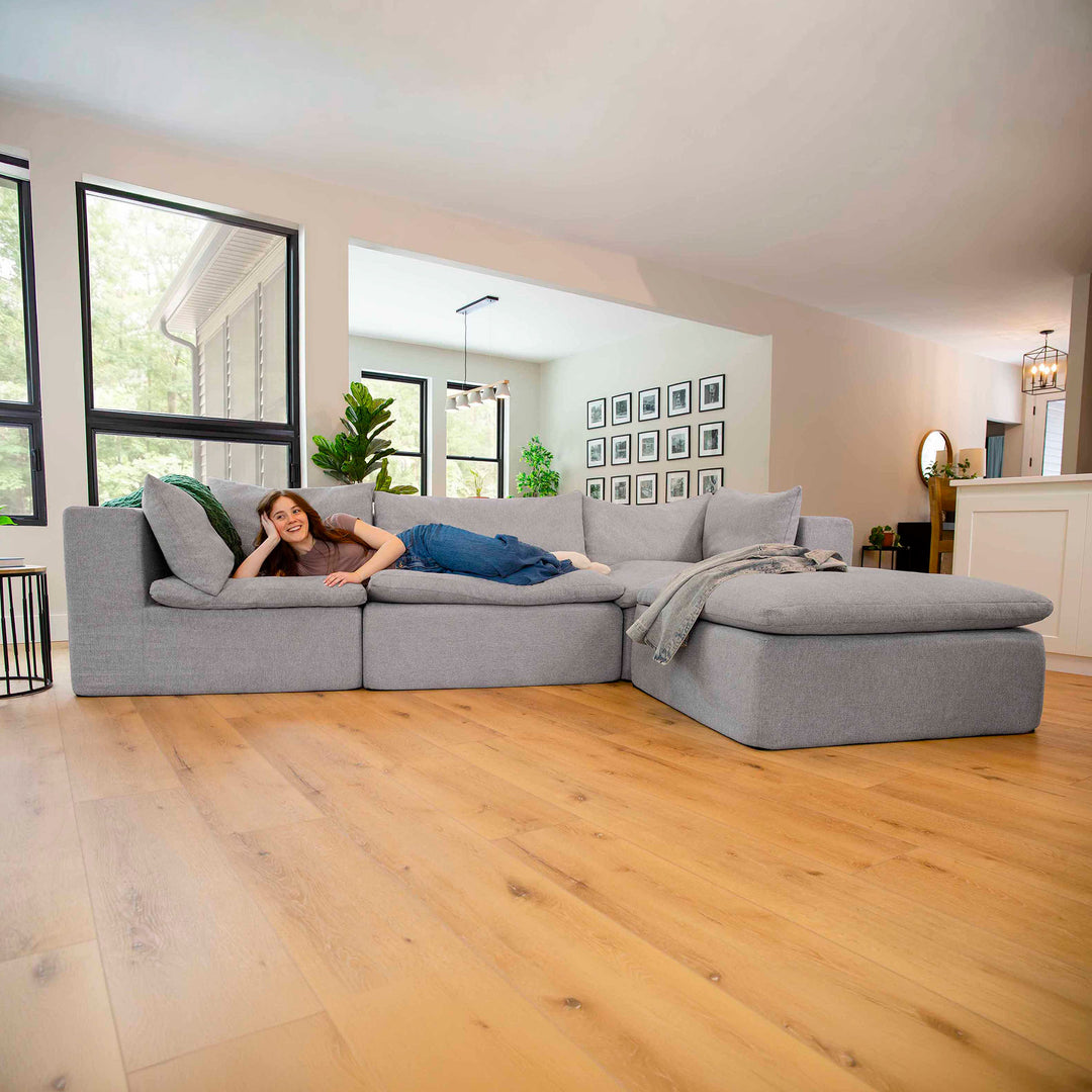 Woman laying on a sectional couch 