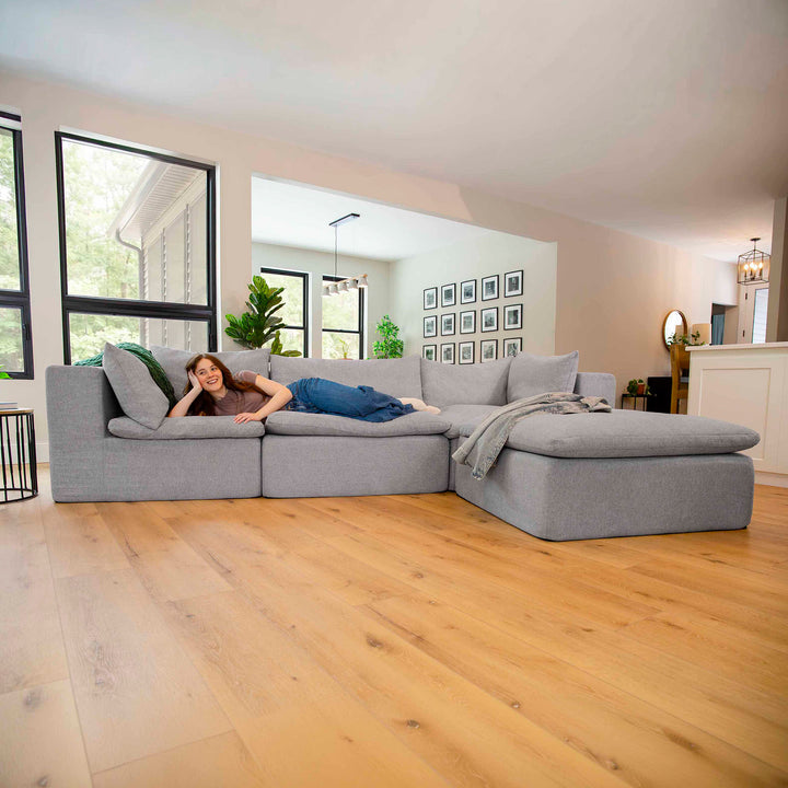 Woman laying on a sectional couch 