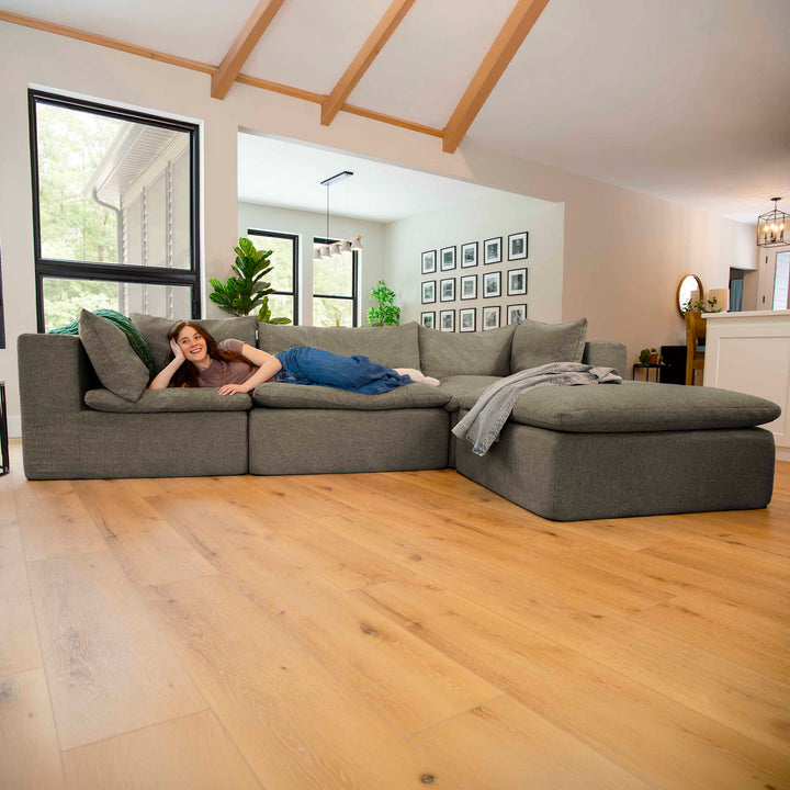 Living room green sectional sofa with woman laying down 