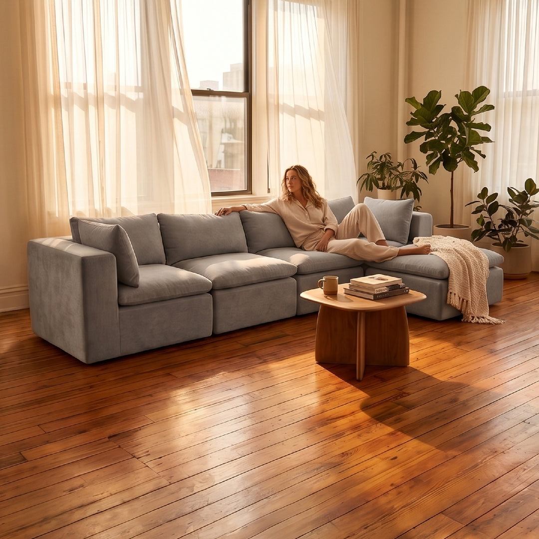 Woman relaxing on a modular sectional sofa with 4 seats and 1 ottoman 