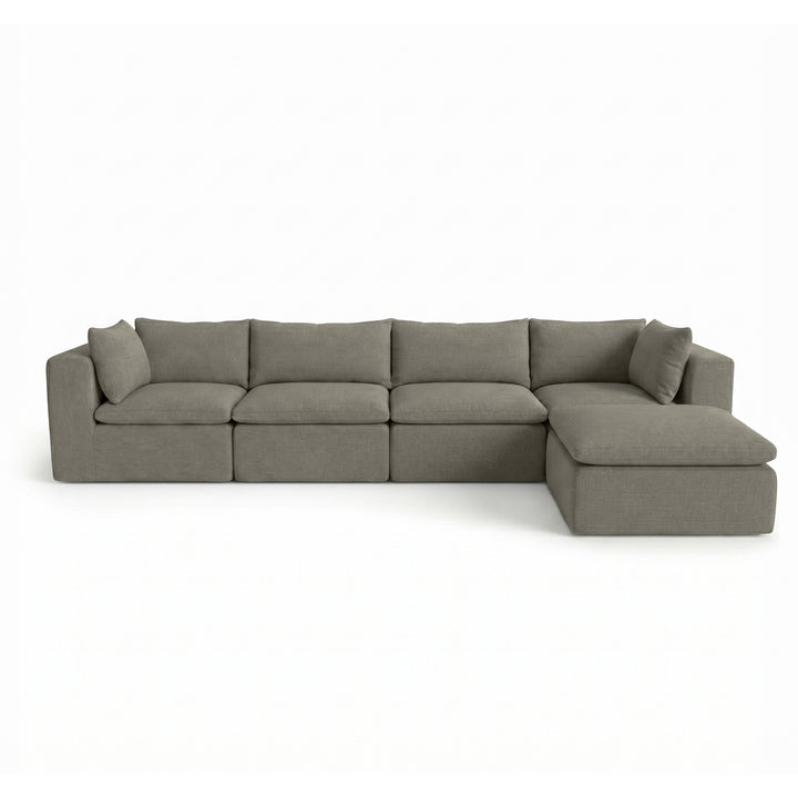 A modern sectional sofa in a textured gray fabric, featuring a left-facing armrest, a right-facing chaise lounge, and four matching back cushions, shown against a plain white background. 