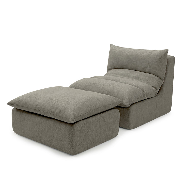 Gray upholstered chair with ottoman on a white background 