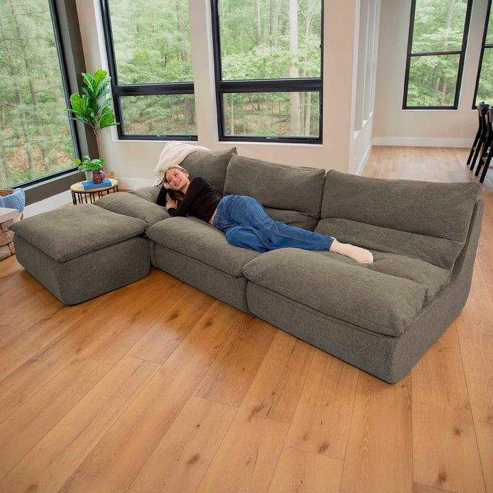 4pc driftscape sectional set with woman lounging 