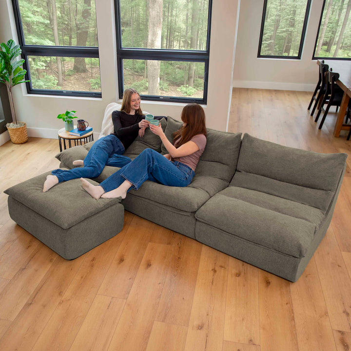 Women enjoying a drink on a 4pc driftscape sectional couch set 