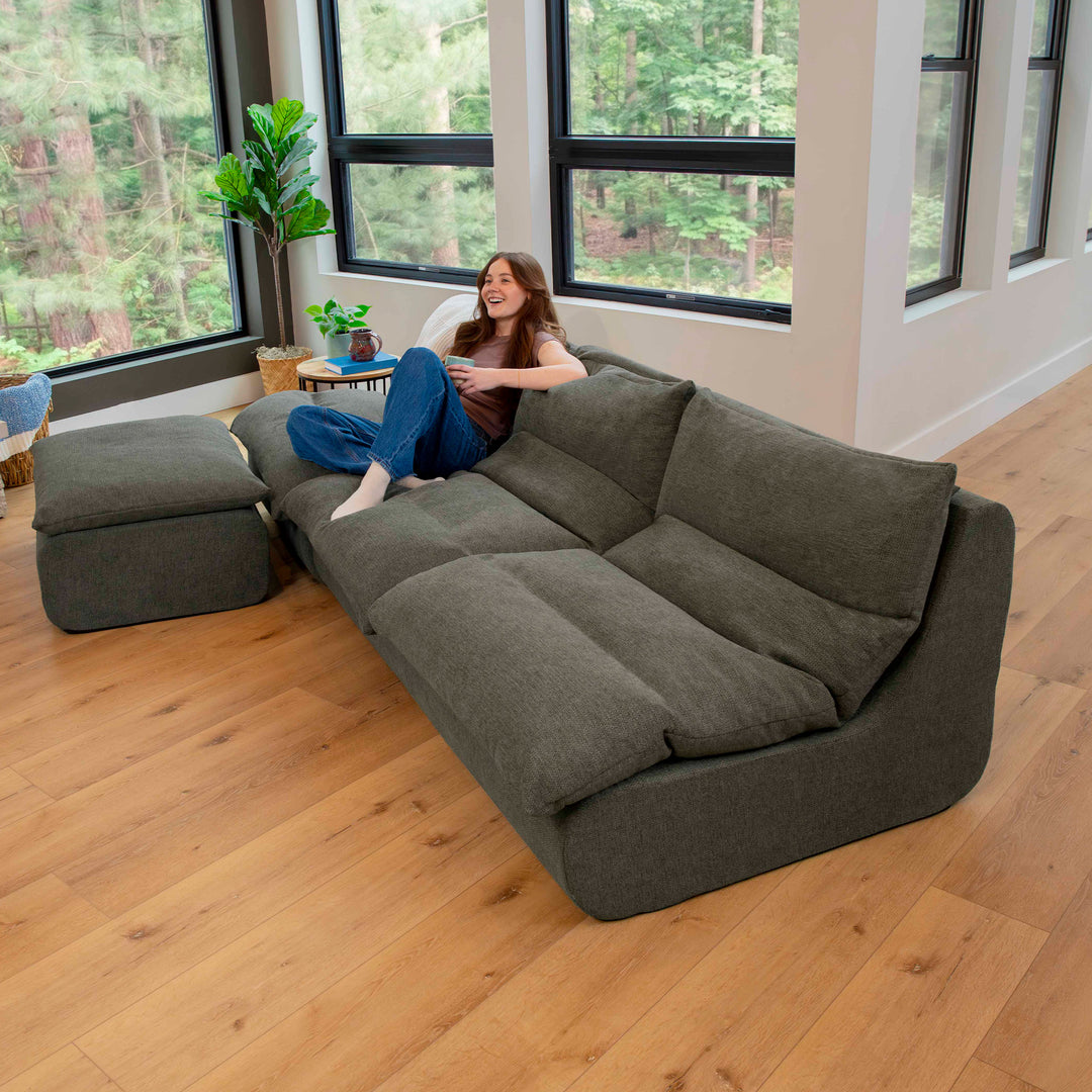 Driftscape sectional sofa with ottoman  woman relaxing on the sofa 