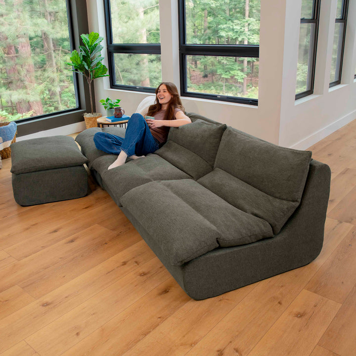 Driftscape sectional sofa with ottoman  woman relaxing on the sofa 