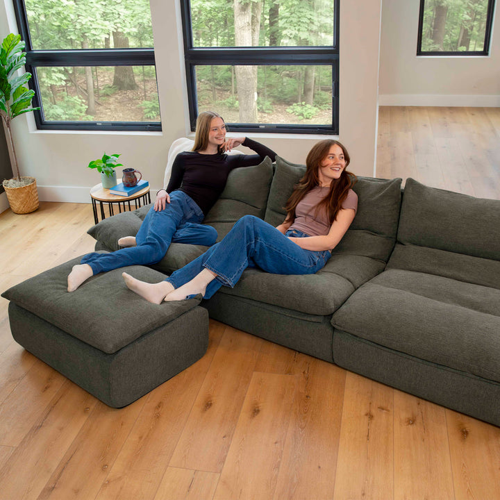 Woman on sectional sofa in living room 