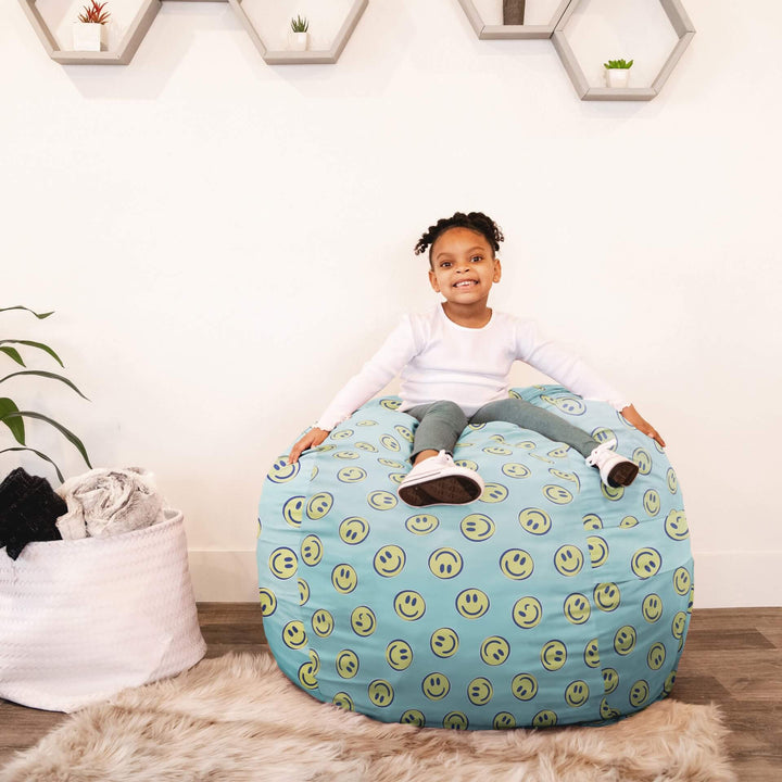 Young girl playing on Fuf medium smiley face foam beanbag chair #color_smiley-face-plush
