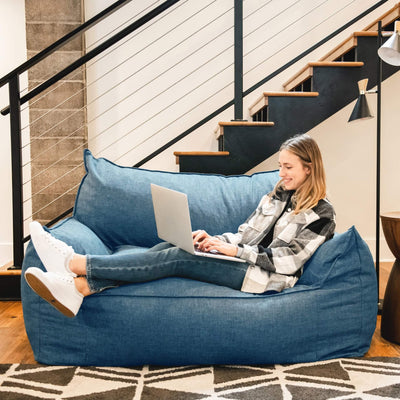 Blue Imperial Fufton Loveseat woman relaxing on computer 